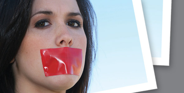 Woman with mouth covered by red tape